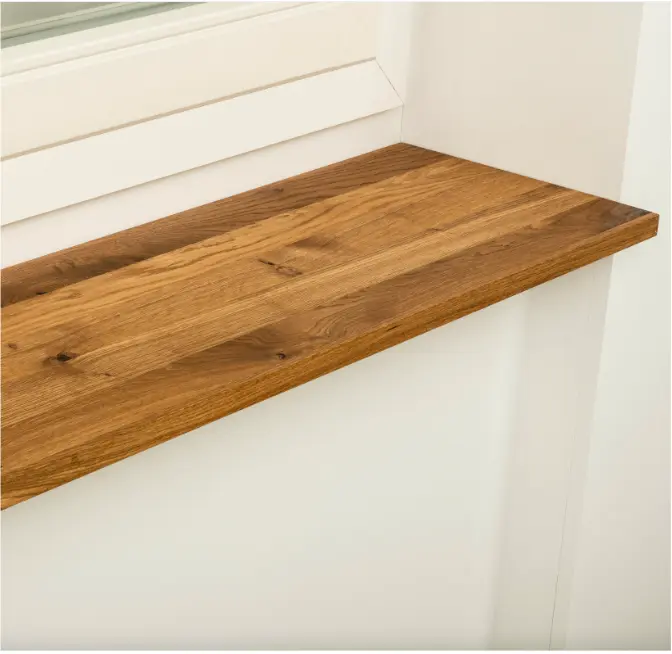 Warm-toned wooden sill adding an elegant touch to a white window frame.